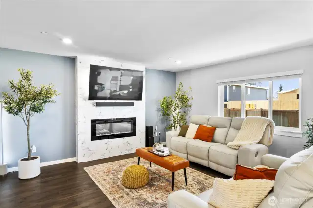 Open and inviting Living Room, electric fireplace and designer fireplace wall!