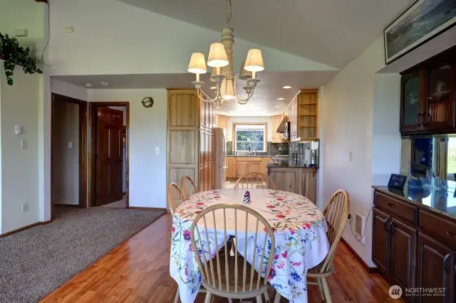 Dining room, kitchen, 1/2 bathroom and doorway to the primary suite