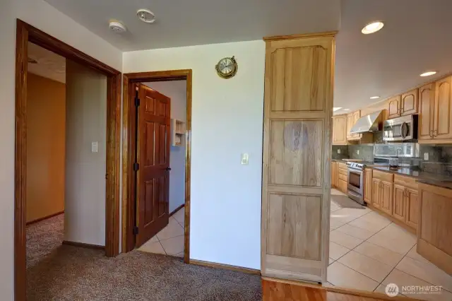 Left door is to the Primary Suite, middle door is the 1/2 Bathroom then the kitchen.