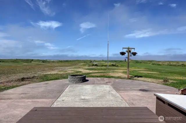 View from the oceanfront deck including the patio, firepit and short walk to the beach.