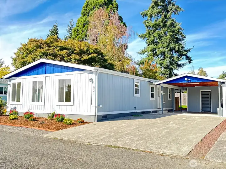 New exterior paint, fresh landscaping with young and mature plants.