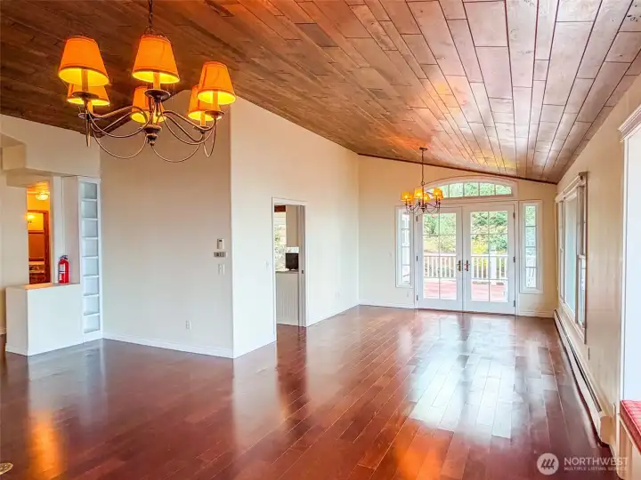 Looking across to the dining room with the large deck out side to capture more view. Kitchen to the left