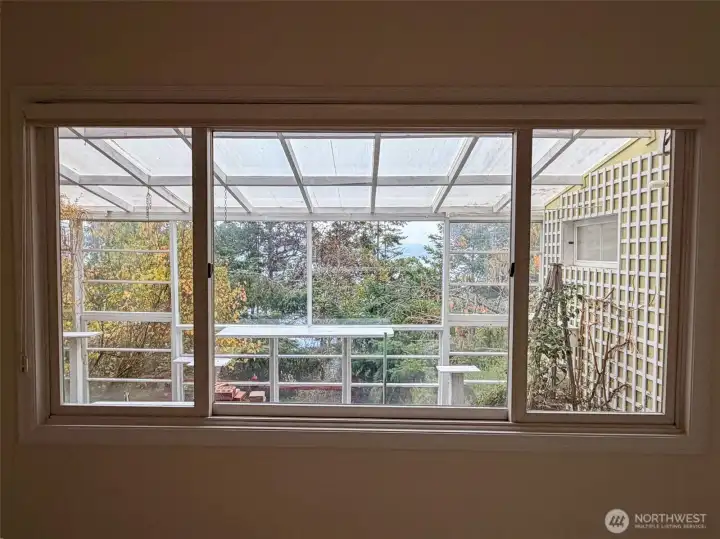 The large green house and partial views. Hot tub on patio to the left of this.