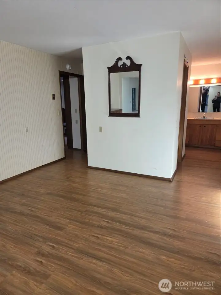 Primary Bedroom looking back toward entry door (which has closet behind it) and hallway into private bathroom and walk-in closet.