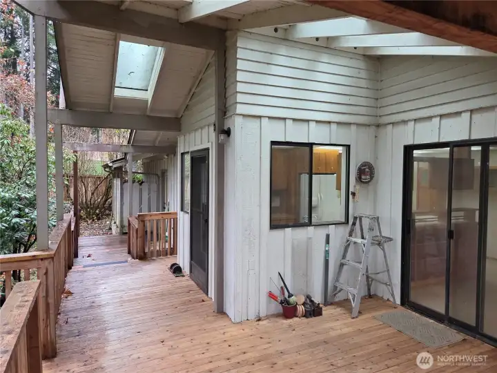 Back deck looking at the kitchen window and sliding door into the dining room.