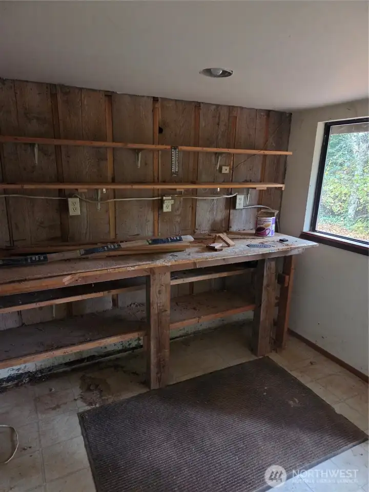 Hidden workshop located under the back deck and is part of the main house. but only accessable from exterior.