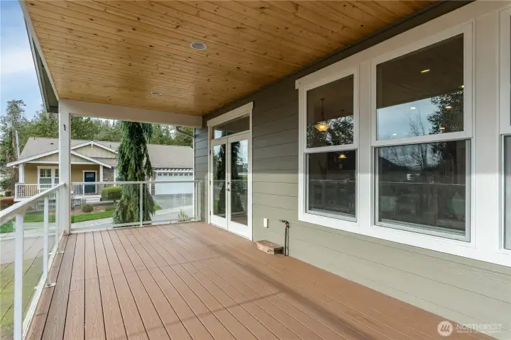 The covered deck off the great room extends the living space to the outdoors with lovely southern views over Burrows Bay.