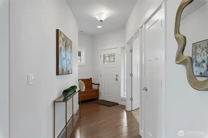 The hallway looking towards the entry from the great room. The door on the right is a closet, the open double doors lead to the den.