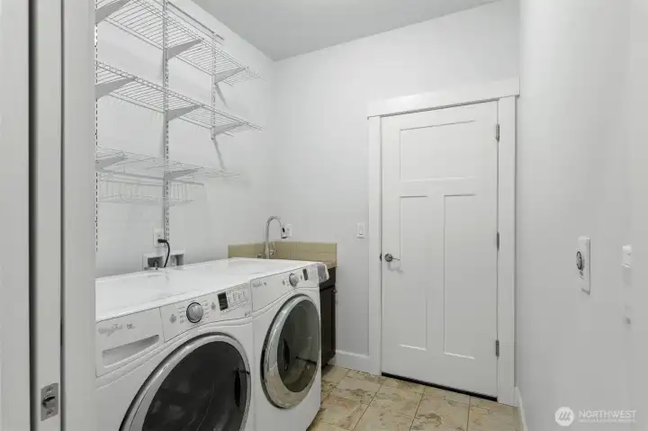 the laundry room with utility sink and access to the garage.