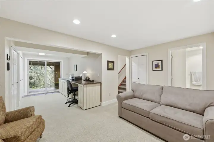 A view from the family room looking towards the back deck off the lower level. Note the area currently used as craft room. What would you love to do with this addition living space?