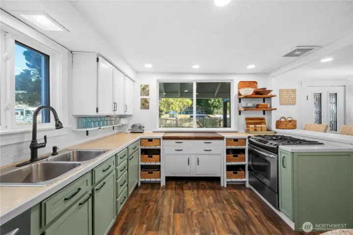 Warm butcher block counter and charming open shelving make this kitchen both functional and full of character.