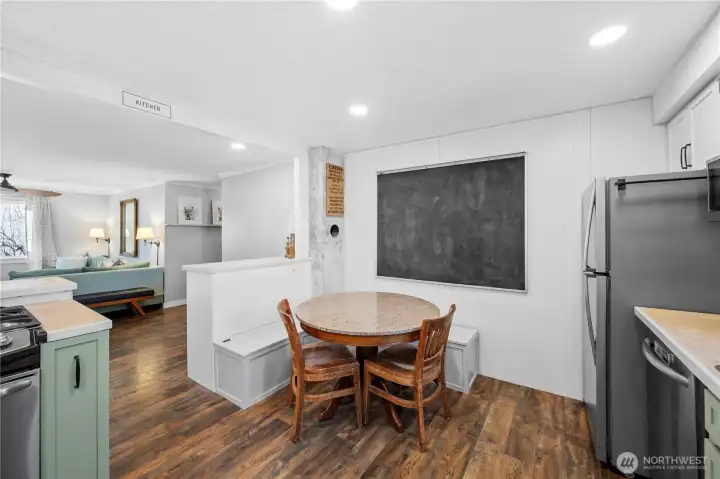 Cozy built-in kitchen bench and chalkboard wall perfect for notes, menus, or creativity.