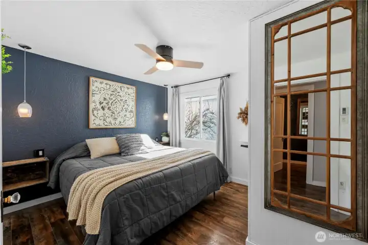 Comfortable primary bedroom featuring a walk-in closet and private half bath.
