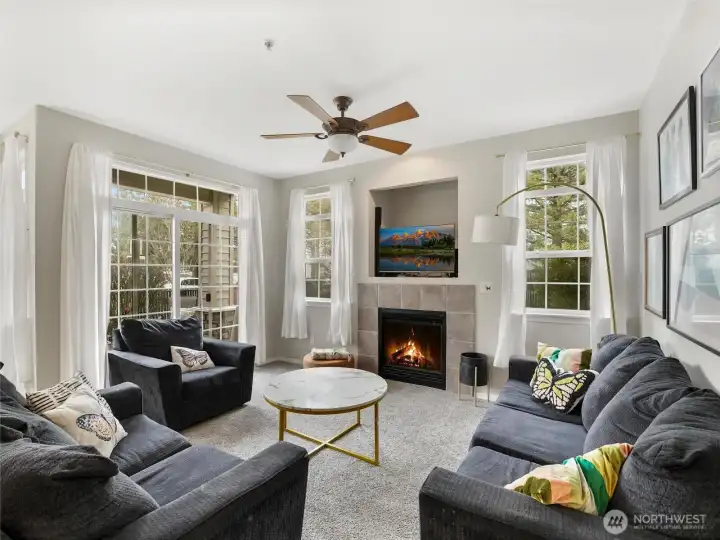 Large windows and a sliding door brighten the living room with natural light.