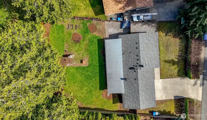 Aerial view of the lot with one level home for sale. Spacious front and backyard.