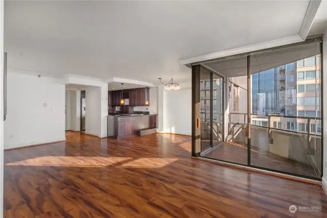 open concept living room dining area and balcony.