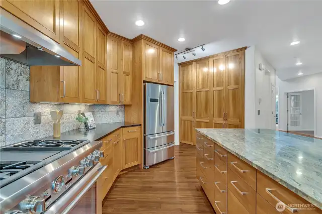 Massive kitchen island with built-in storage on both sides, combining functionality with ample workspace for all your needs