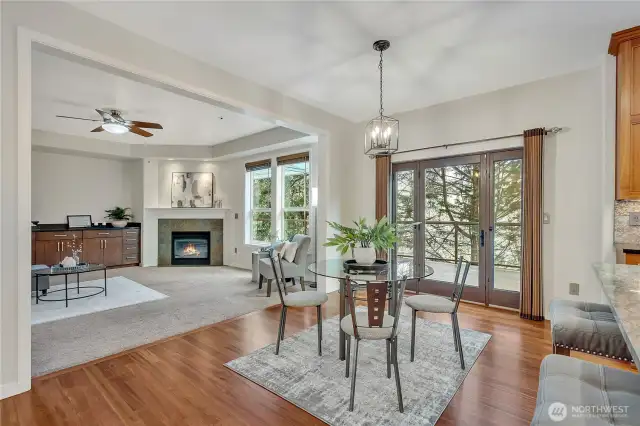 Bright and spacious eat-in kitchen with casual dining area, ample seating at the island, and a seamless flow into the inviting family room. Large windows and French doors frame views of the expansive covered back deck, seamlessly blending indoor comfort with outdoor living.