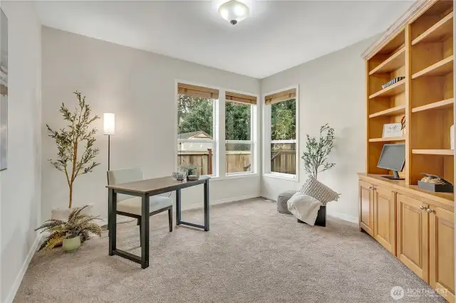 Spacious office featuring built-in cabinetry that seamlessly combines storage solutions with sophisticated style.
