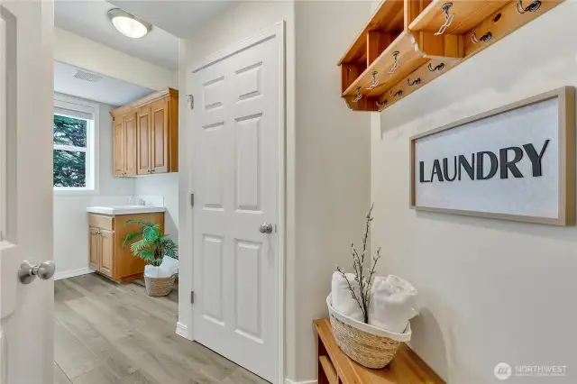 Convenient laundry/mudroom perfectly situated next to the garage and kitchen—complete with a linen closet for added storage and organization, ready to handle those dirty soccer clothes with ease!