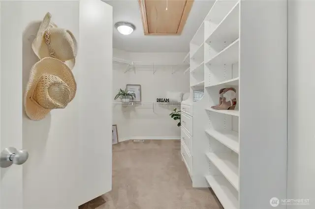Spacious walk-in closet equipped with built-in organization, offering practical storage solutions with effortless style.