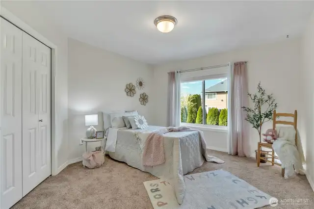 One of five bedrooms, including the primary, on the second floor, this room features a cozy touch with built-in closet organization for added functionality.