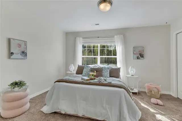 Another of the five spacious bedrooms, offering comfort and flexibility for family or guests. The closet offers some built-in storage.
