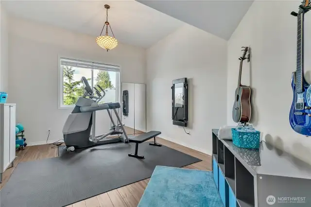The final bedroom, featuring a soaring vaulted ceiling, was transformed into a home gym. Please note, exercise equipment is not included in the sale, but could be negotiated....