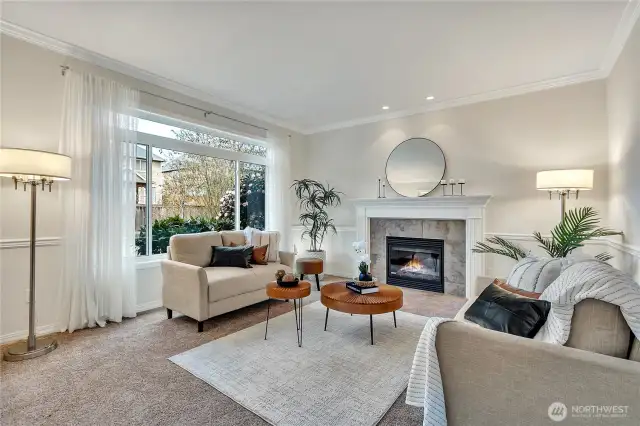 Elegant formal living room featuring one of the home's three cozy gas fireplaces, perfect for relaxation and entertaining