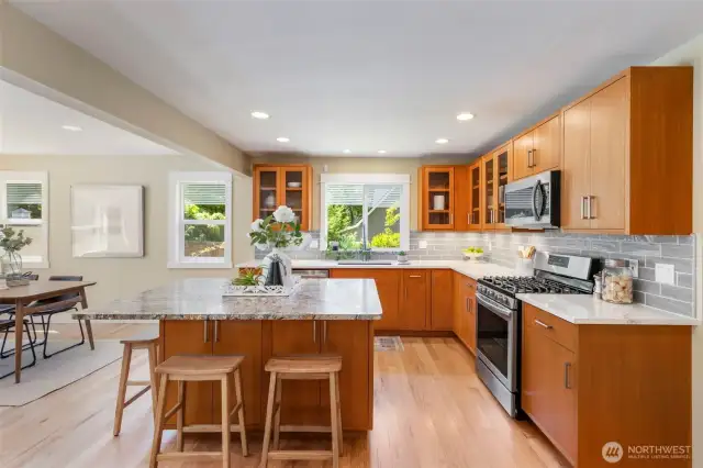 A true entertainer’s kitchen with ample counter space, stainless appliances, and seamless flow into the dining area.