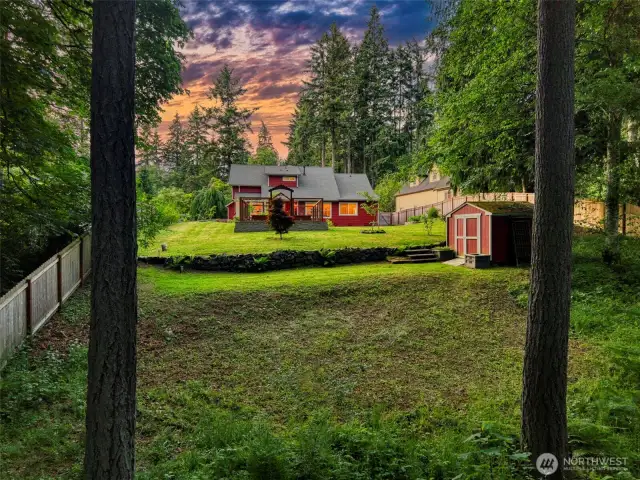 Lush, landscaped grounds frame the home beautifully, with a fully fenced yard perfect for play or peaceful retreat.