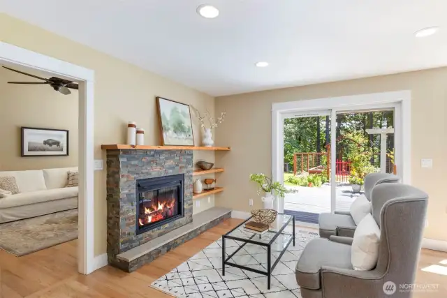 Cozy up by the propane fireplace in this inviting family room, filled with natural light and peaceful garden views.