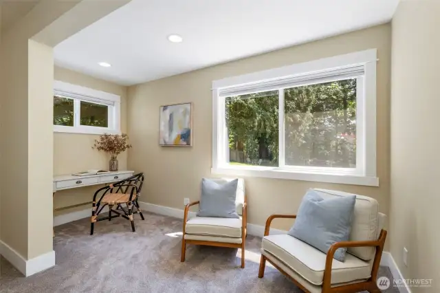 A cozy sitting area in the primary suite creates the perfect nook for morning coffee or a quiet escape.