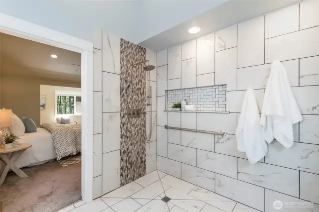 A spa-like walk-in shower with tile surround and rainfall showerhead elevates your daily routine.
