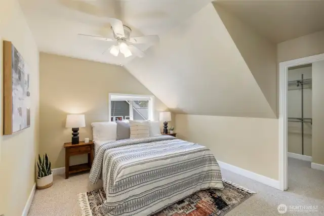 Charming upstairs bedroom offers comfort, light, and a serene view of the surrounding landscape.