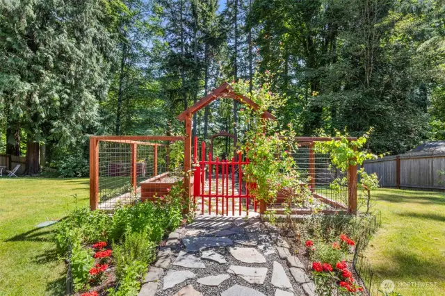 A charming arbor leads through lush gardens, creating a storybook path to your private backyard oasis.