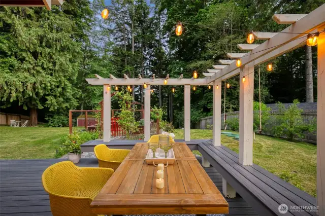 Savor summer evenings on the custom-crafted deck with a modern pergola and built-in seating—perfect for dining al fresco.