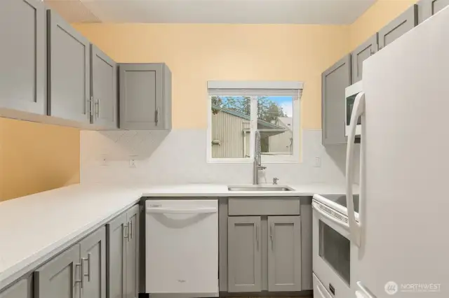 Plenty of cabinets in this functional kitchen with passthrough to the dining area.
