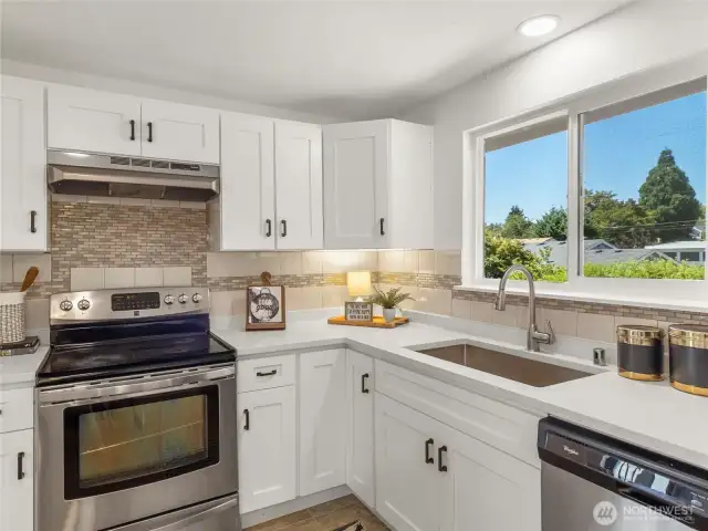 All new cabinets, countertops, kitchen sink, and hood vent. All appliances stay!