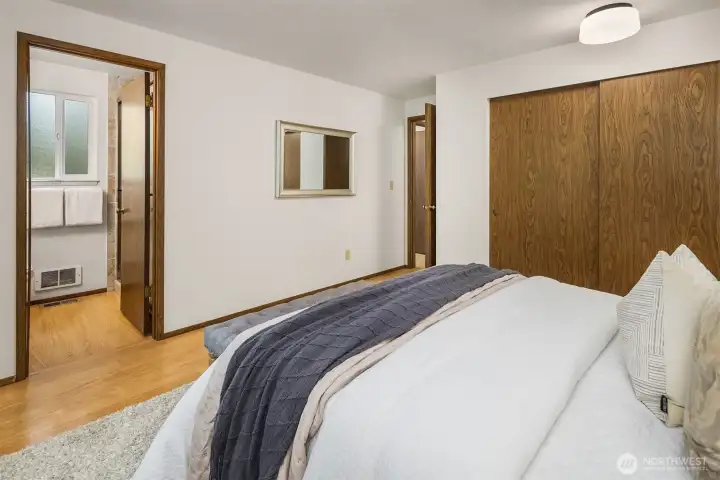 Primary bedroom showing 3/4 ensuite and full size closet