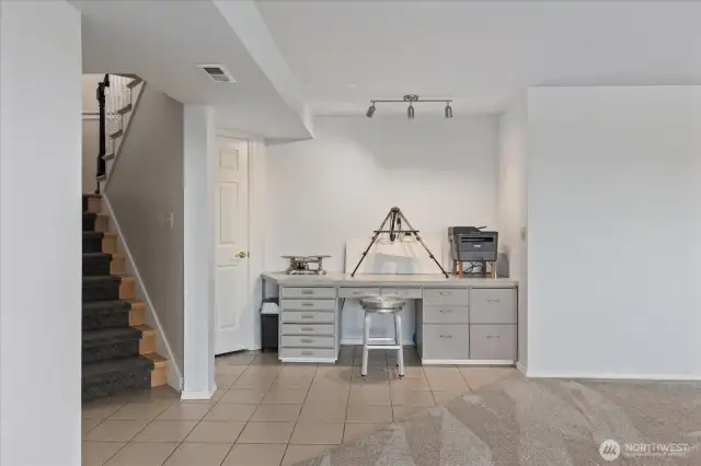 Built in desk area and lots of storage under the stairwell.