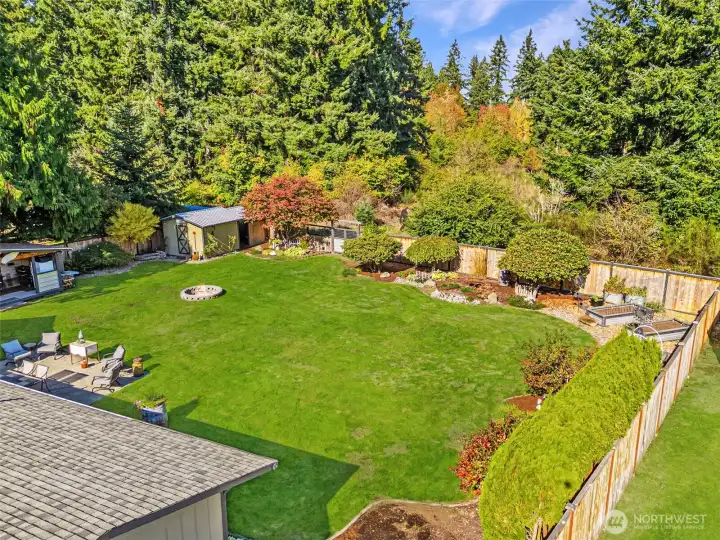 Huge, fenced rear yard with BBQ cabana and large storage shed with lean to.