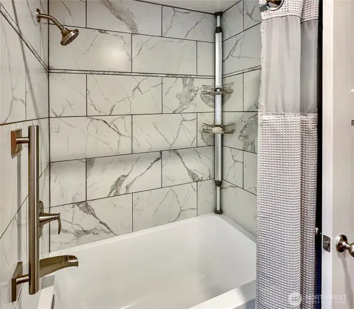 Extra deep soaking tub with gorgeous tile surround and shower.