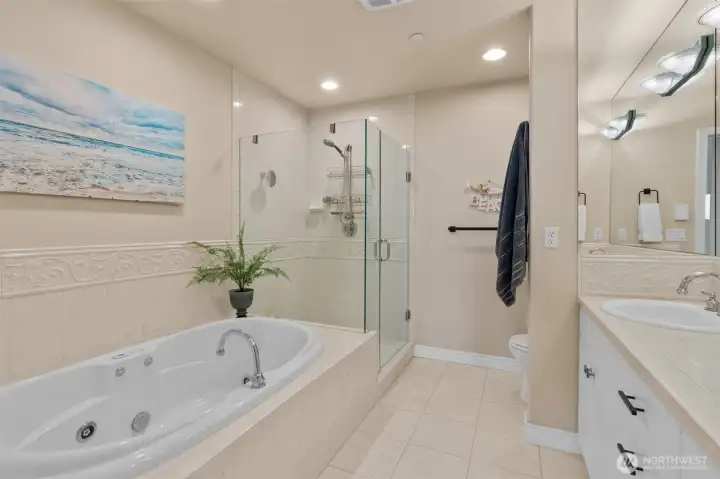 Five-piece primary bath with jetted soaking tub, dual sinks and separate shower.