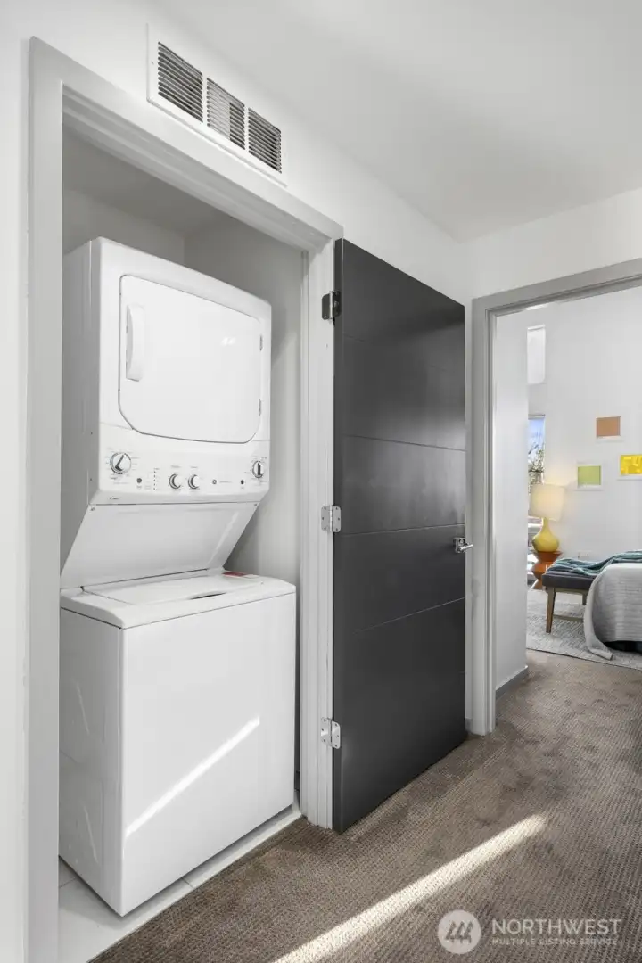 In-unit laundry is neatly tucked away for everyday convenience.