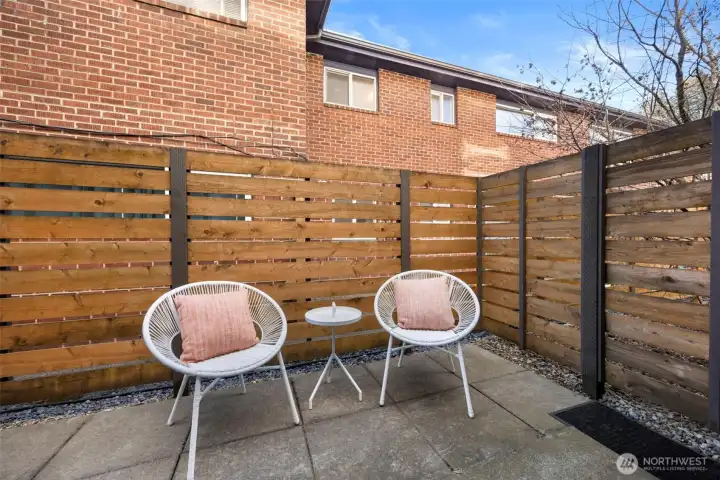 A fenced patio offers a quiet outdoor spot for relaxing, dining, or entertaining.