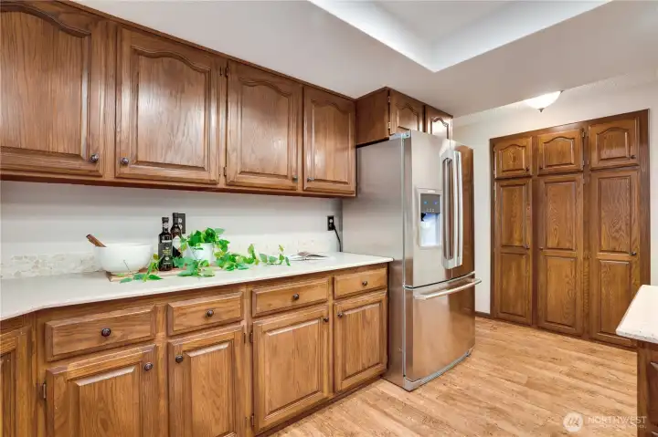 Wall of pantry storage, extra counter space, and stainless fridge—plenty of room to stock up, meal prep, and keep the kitchen running smoothly for a busy household.