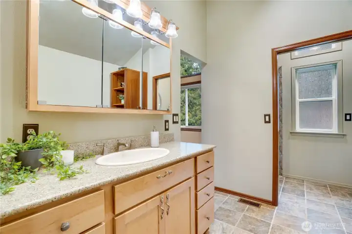 Primary ensuite bath with long vanity, loads of storage!