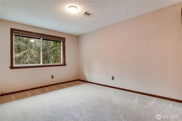 Third upstairs bedroom with large window overlooking the trees.