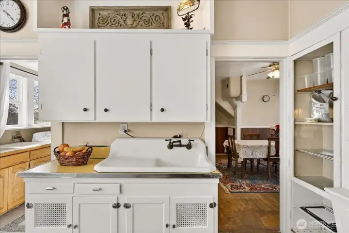 Beautiful authentic 1890 features, especially that classic high-back sink and the original built-in cabinets. You can see how perfectly the kitchen connects to the dining room, making it easy to host friends and family. Beautiful functional farmhouse layout that’s stood the test of time for 136 years.